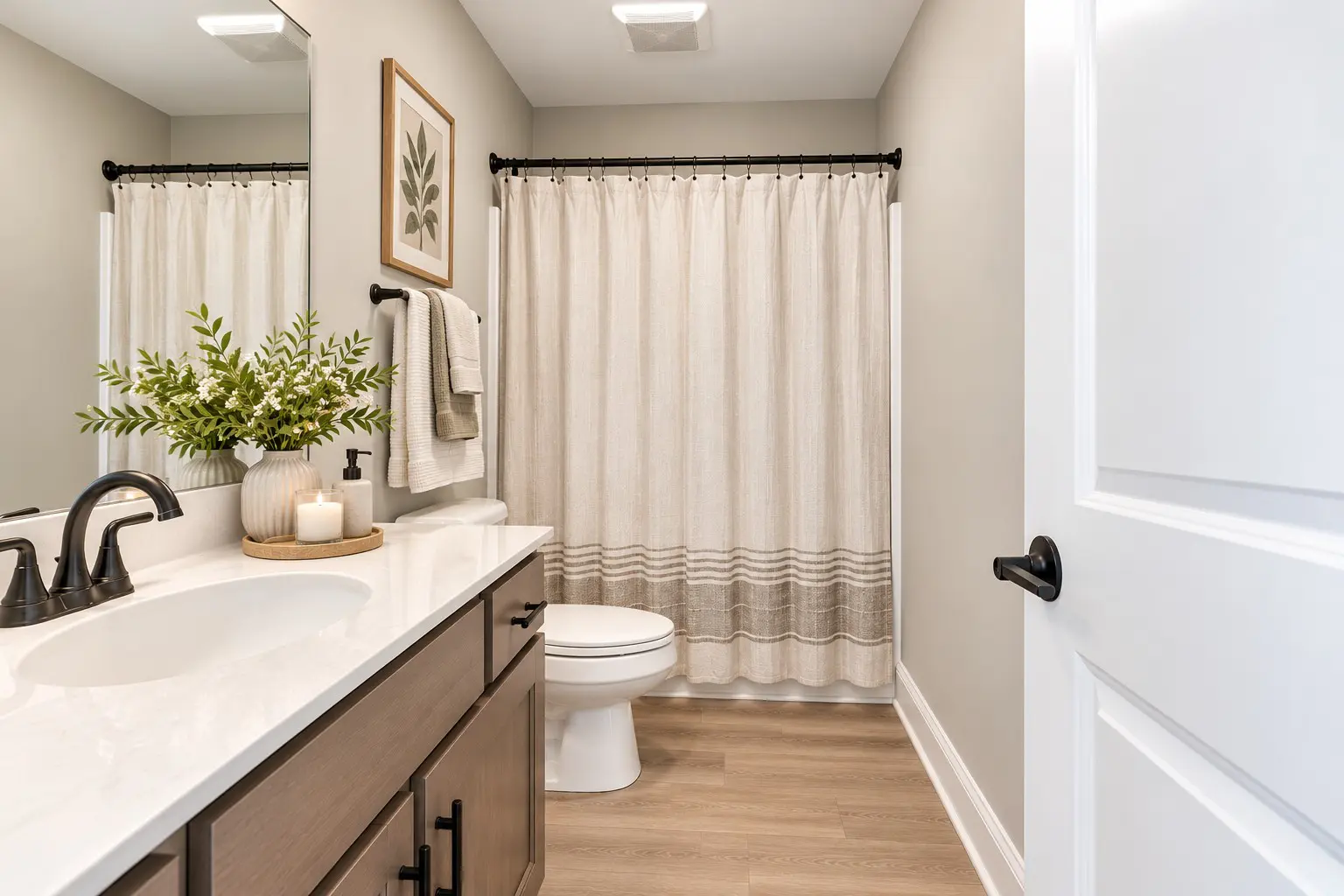 Cozy neutral bathroom with wood flooring