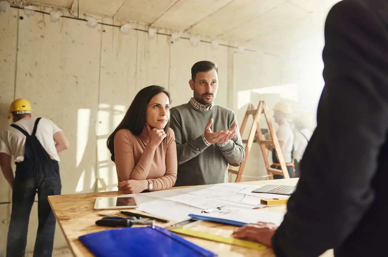 Couple planning home renovation with builder